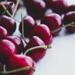Dark berries of ripe sweet cherry on a white background.
